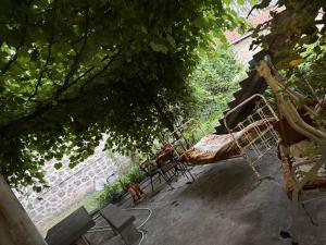 a group of chairs and a hammock under a tree at Joni Mot in Goris +2 photos