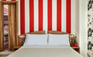 Posteľ alebo postele v izbe v ubytovaní ACasaMia WelcHome Hotel