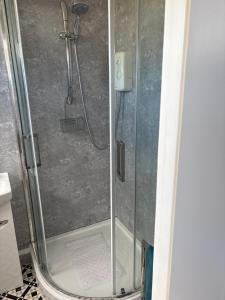 a shower in a bathroom with a glass door at 78 Belle Aire in Hemsby