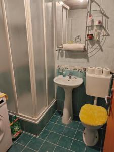a bathroom with a sink and a toilet and a shower at Apartman Angela in Budva