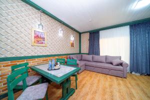 a living room with a couch and a table at Quba Qala Resort in Quba