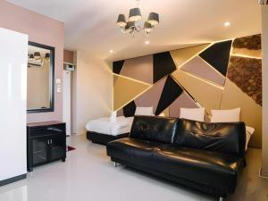 a living room with a couch and a bed at Debua Mahasarakham in Maha Sarakham