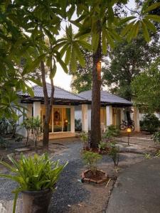 a house with palm trees in front of it at Green Haven Villas in Krabi