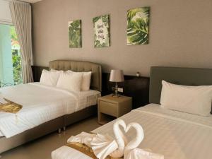 a hotel room with two beds with hearts on them at Green Haven Villas in Krabi +33 photos