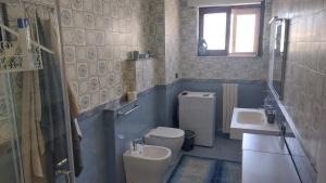 a bathroom with a toilet and a sink at A Casa di Nonna Lidia in Crotone