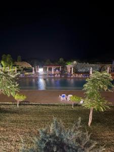 a view of a swimming pool at night at Studio Blaxy Mihnea in Douăzeci şi Trei August