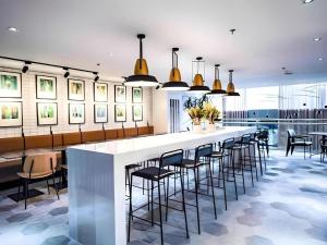 a large kitchen with a long bar with stools at Avior Hotel in General Santos