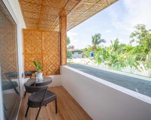 a room with a view of the balcony of a house at Yellow Mango Resort Bohol in Panglao Island