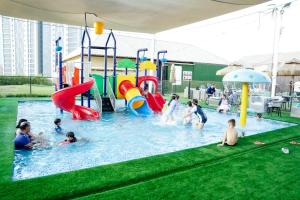 a group of people playing in an outdoor playground at Ras Al Khaimah Hotel in Ras al Khaimah