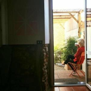 a woman sitting in a chair on a patio at I tre jack Malpensa in Case Nuove