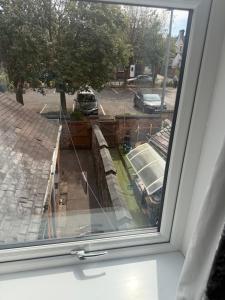 a window with a view of a street at High End Central Location 2 Bedroom in Stoke on Trent
