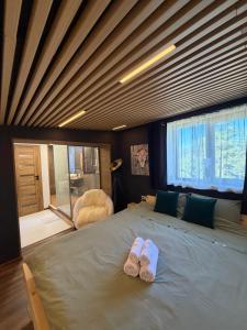 a bedroom with a bed with two slippers on it at Villa INDIANA Devin in Devin +89 photos