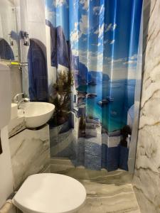 a bathroom with a toilet and a sink and a shower curtain at Ploiești Centru in Ploieşti
