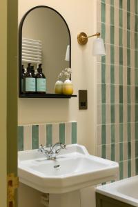 a bathroom with a sink and a mirror at The Lodge at Dabton House in Carronbridge +23 photos