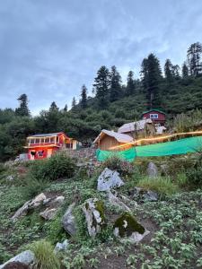 a group of houses on top of a hill at Skyblue cafe in Tosh