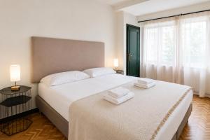 a bedroom with two beds with towels on them at ZUBIETA by SWEET HOME SAN SEBASTIAN in San Sebastián