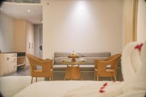 a living room with a couch and a table and chairs at The Surya Golden Palace, Pushkar in Pushkar