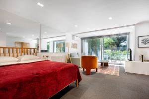 a bedroom with a red bed and a large window at NOA - Sungu 1 in Istanbul