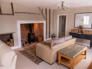 a living room with a couch and a fireplace at The Old Reading Rooms Linton in Linton