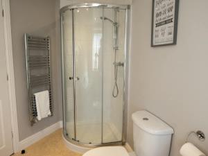 a bathroom with a glass shower and a toilet at The Old Reading Rooms Linton in Linton +22 photos