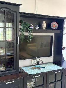 a kitchen with a tv on a counter at Mi casa homestay in Guwahati