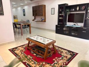 a living room with a table on a rug at Mi casa homestay in Guwahati