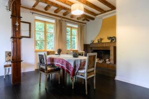 a dining room with a table and chairs and a fireplace at Appartement Cadichon in Munster