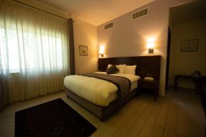 a bedroom with a large bed and a window at Lavender Boutique Hotel in Ramallah +55 photos