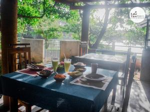 a blue table with plates of food on it at Lake View Dambulla in Dambulla