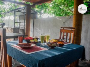 a blue table with bowls of food and drinks on it at Lake View Dambulla in Dambulla +66 photos