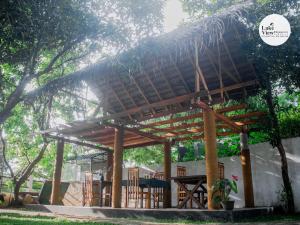 a wooden pergola with a roof at Lake View Dambulla in Dambulla