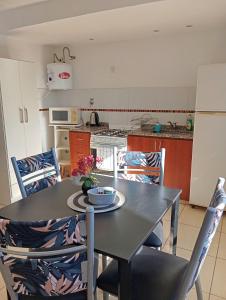 a kitchen with a table with chairs and a table and a table at El Depto de Roberto in Villa María +19 photos