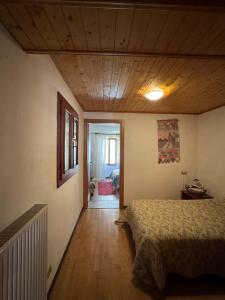 a bedroom with a bed and a wooden ceiling at Casa Camomilla in Creto