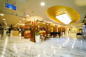 a lobby of a store with tables and chairs at Ras Al Khaimah Hotel in Ras al Khaimah +86 photos