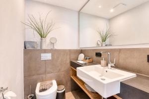 a bathroom with a sink and a toilet at Ferienwohnung Strandperle in der Villa Martha Binz in Binz +11 photos