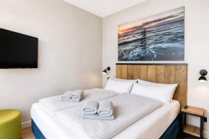 a bedroom with a bed with two towels on it at Ferienwohnung Sandbank in der Villa Martha Binz in Binz