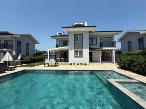 a house with a swimming pool in front of a house at Sever Apart in Gaziantep
