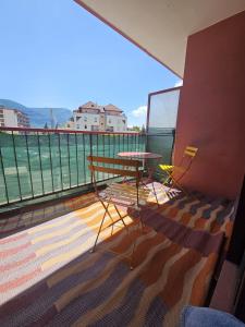 a balcony with a table and chairs on a balcony at Refuge Gaillard Tramway in Gaillard