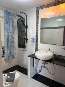 a bathroom with a sink and a toilet and a mirror at Lagoon vibes in Pattaya +49 photos