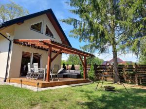 a house with a deck with a gazebo at Świerkowy Las in Sanok