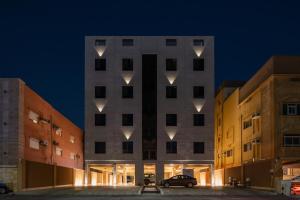 a building with lights on the side of it at الاخشبان in Jeddah