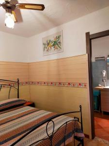 two twin beds in a bedroom with a ceiling at B&B Meladormo in Tempio Pausania