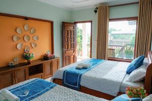 a hotel room with two beds and a balcony at Mai Mountain Homestay in Ninh Binh +105 photos