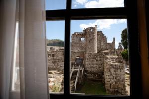a view of a castle from a window at O Recuncho do Castelo in Ribadavia