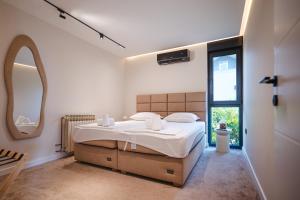 a bedroom with a large bed and a large window at Villa View Mostar with Heated Pool & Jacuzzi in Mostar