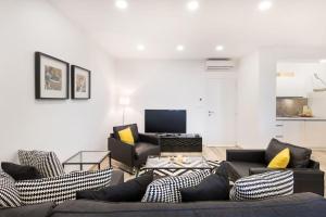 a living room with two couches and a tv at Modern Penthouse Split with Jacuzzi & Terrace in Split