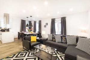 a living room with a couch and a table at Modern Penthouse Split with Jacuzzi & Terrace in Split