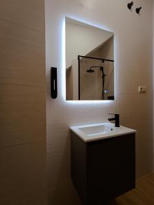a bathroom with a sink and a mirror at O Recuncho do Castelo in Ribadavia +18 photos