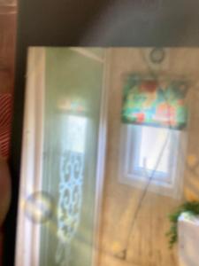 a door with a window and a curtain on it at D andJ caravan in Winthorpe