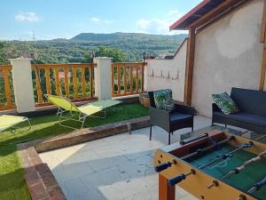 a patio with a ping pong table and chairs at Apartmán Merkur in Kadaň